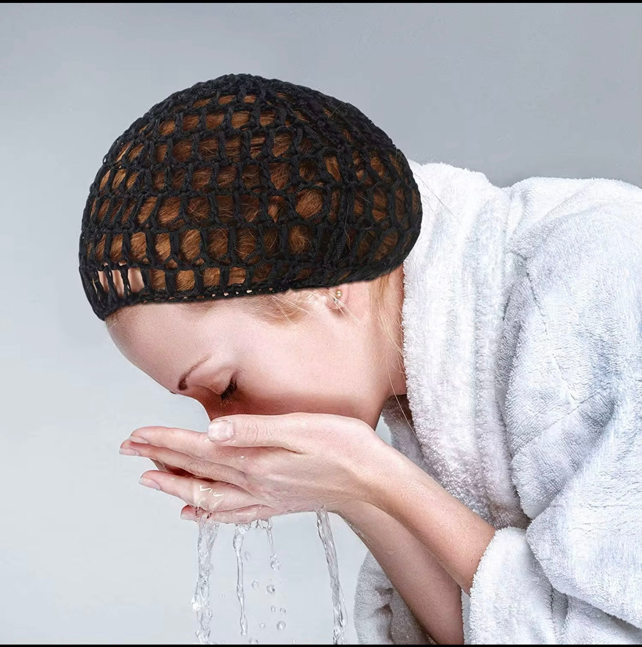 Person wearing a black mesh cap